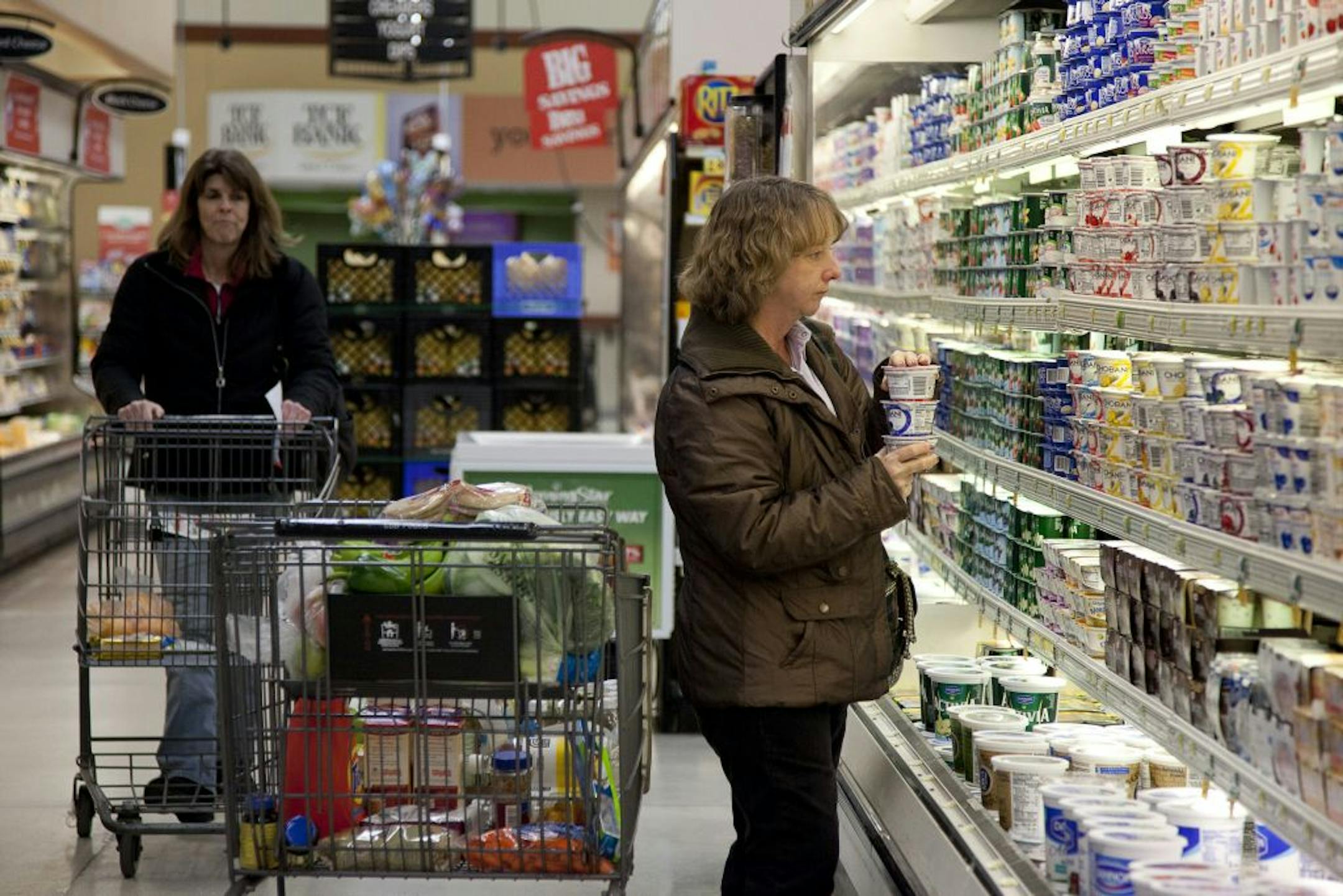 Jane Casper, right, shops for yogurt at a Cub Foods owned by Supervalu Inc. in Crystal, Minn.