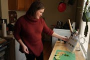 Jessica Bergman, a longtime Marley Spoon user, prepares one of their meal kits of stir-fried curry rice noodles with Chinese broccoli and peanuts for 