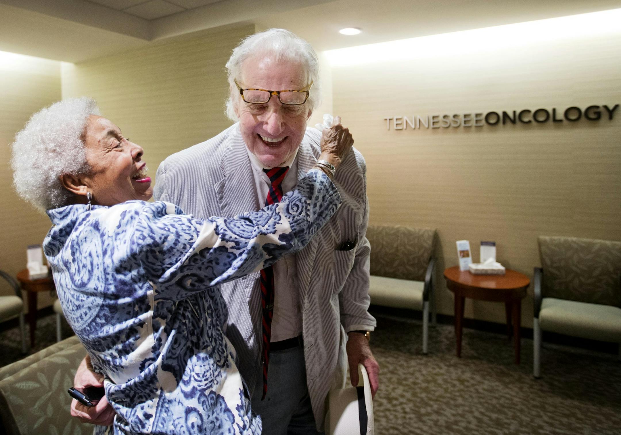 ADVANCE FOR USE MONDAY, NOV. 16 - In this photo taken Aug. 20, 2015, Corrinne Matthews, left, who was dropping off a friend at the hospital, embraces John Jay Hooker after bumping into him before his doctor's appointment in Nashville, Tenn. "I’ve been asking myself how am I going to find him because I want to sign up for what he’s doing." said Matthews. "It’s just God’s luck I’m here today." (AP Photo/David Goldman)