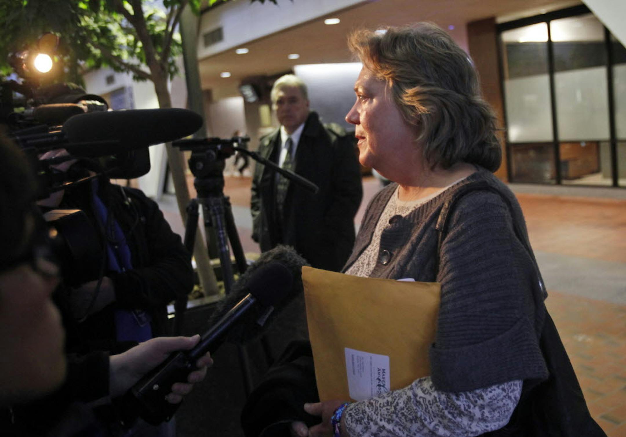 Lana Barnes spoke to media members while her brother, Lynn Hansch, looked on following Wednesday's Hennepin County Court hearing to decide the fate of her husband, Al.