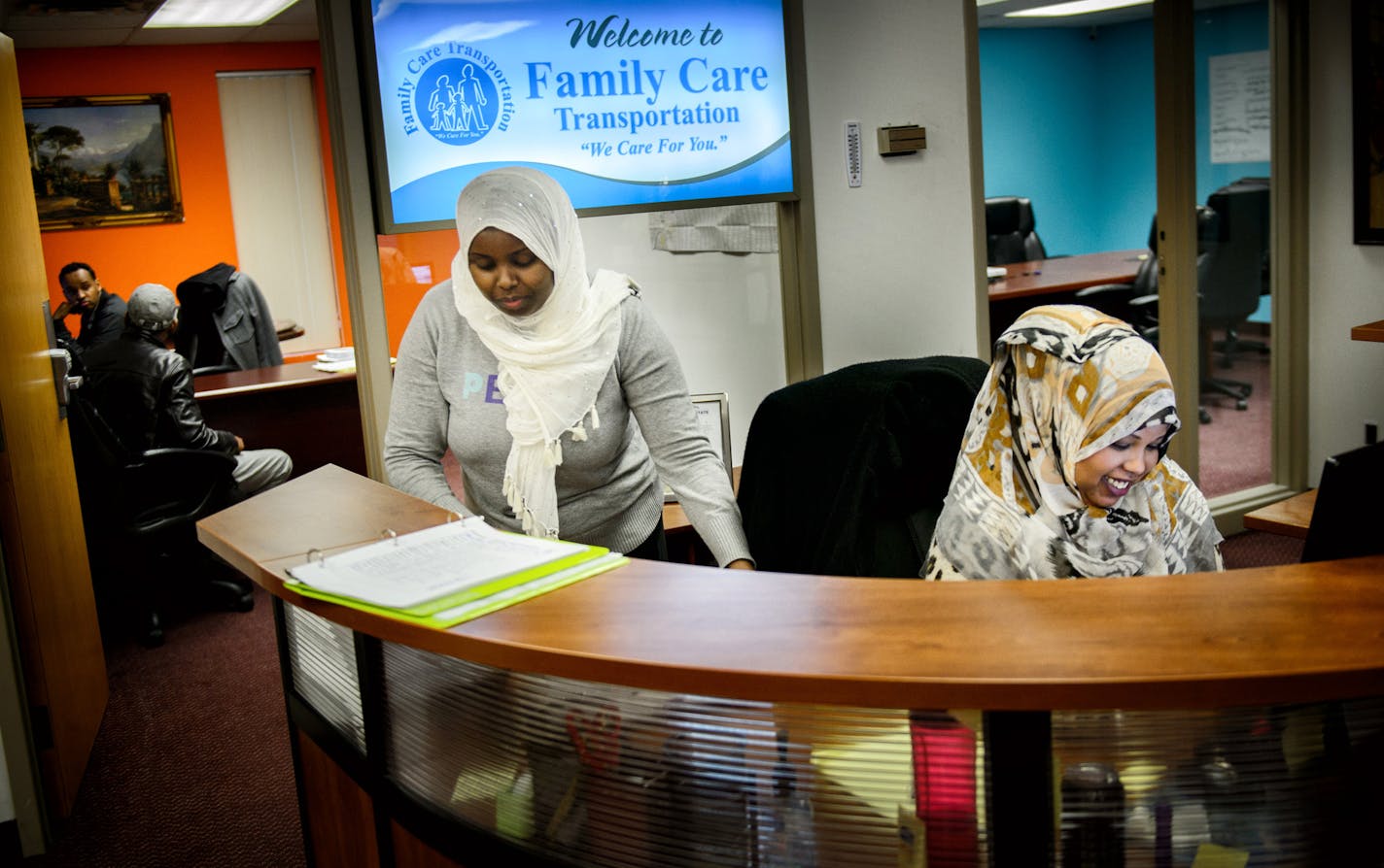 Hibo Abdi,center, director of operations for Family Care Transportation, one of the Muslim owned businesses in St. Anthony Business Center where they hope to use empty space in the basement as a prayer space. ] GLEN STUBBE * gstubbe@startribune.com Monday, December 22, 2014 St. Anthony City Council is expected to reverse course Tuesday night and allow a mosque in the city's business park. It took a federal civil rights lawsuit filed by the US Attorney to reach this agreement.