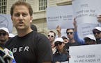 Josh Mohrer, left, New York's general manager for Uber, speaks during a press conference rally outside City Hall, while inside lawmakers hold a hearin