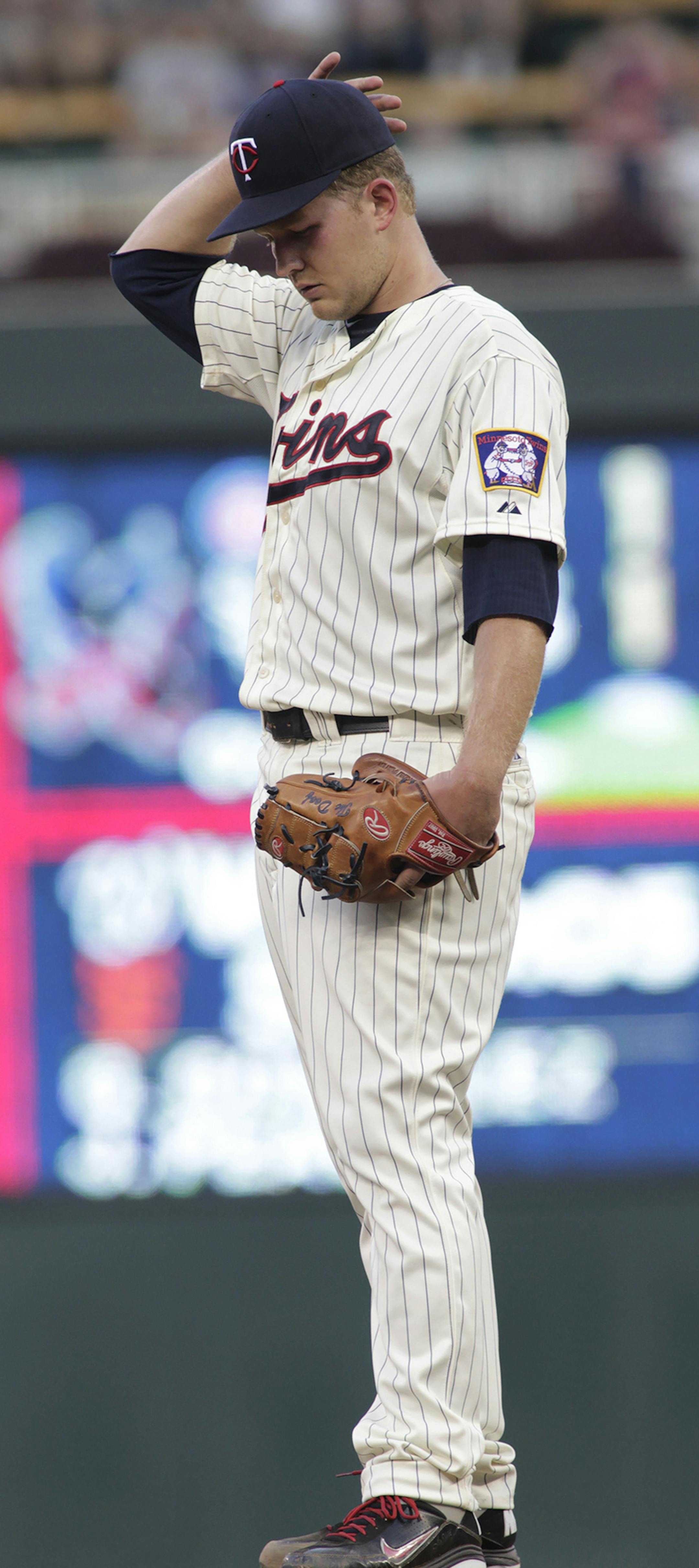 Minnesota Twins starting pitcher Tyler Duffey adjusts his cap during the fifth inning of a baseball game against the Cleveland Indians on Saturday, Aug. 15, 2015, in Minneapolis. Duffy picked up his first win in the majors as the Twins won 4-1. AP Photo/Paul Battaglia)