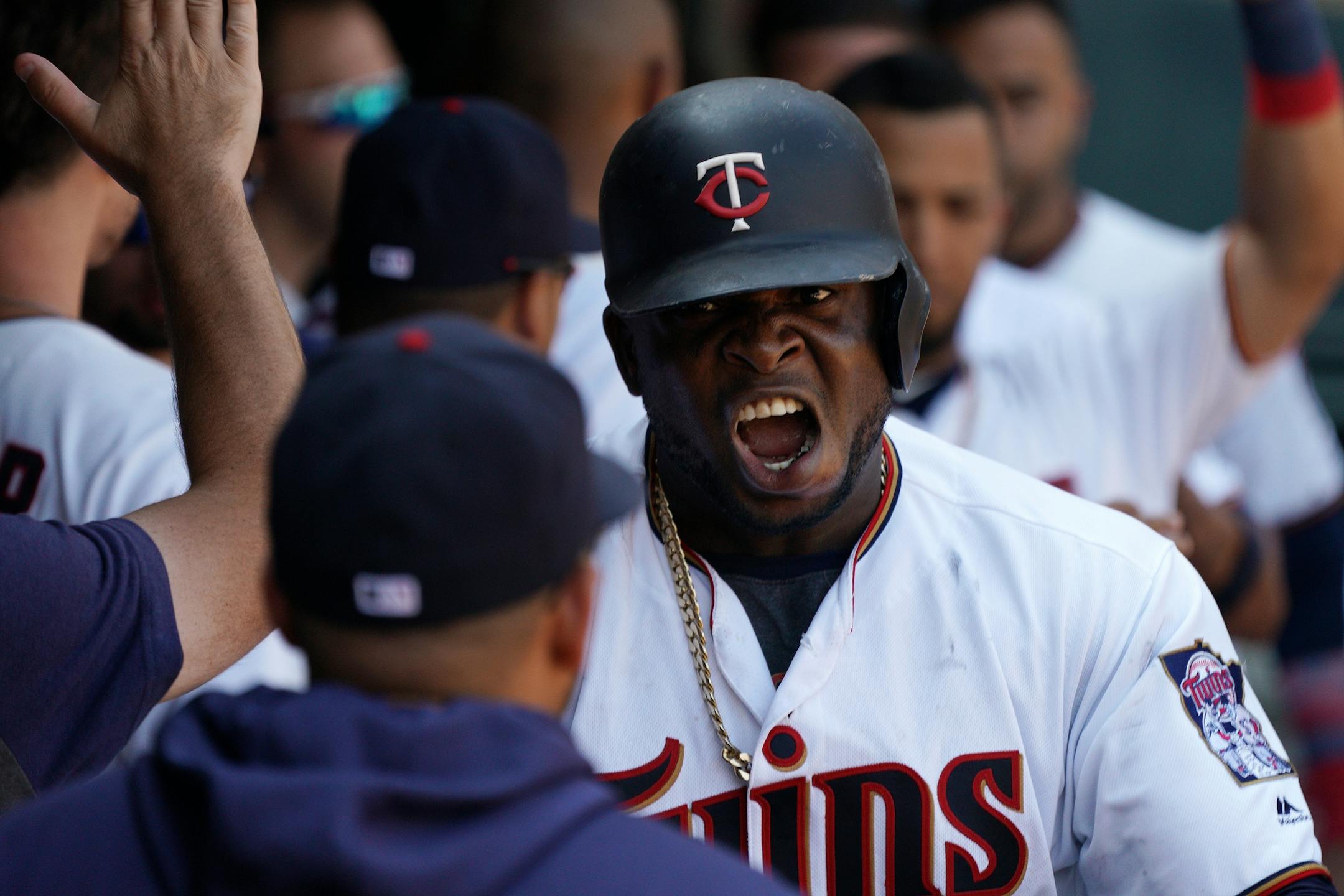 Minnesota Twins third baseman Miguel Sano (22) celebrated with Twins communications assistant and Spanish interpreter Elvis Martinez in the dugout after he hit a three run home run in the ninth inning.