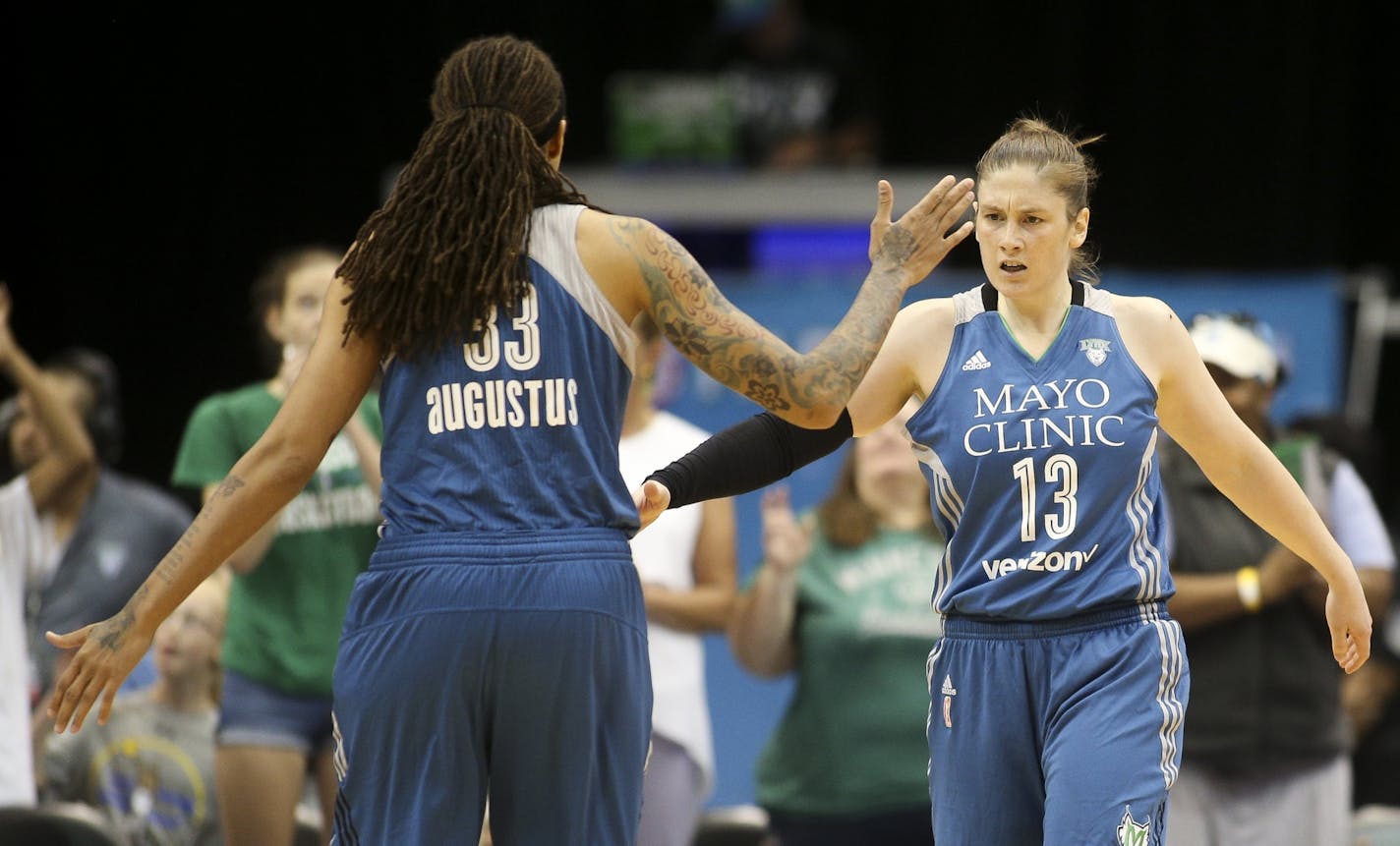 Minnesota Lynx guard Lindsay Whalen (13) is congratulated by Minnesota Lynx guard Seimone Augustus (33) after being fouled during a game in July.