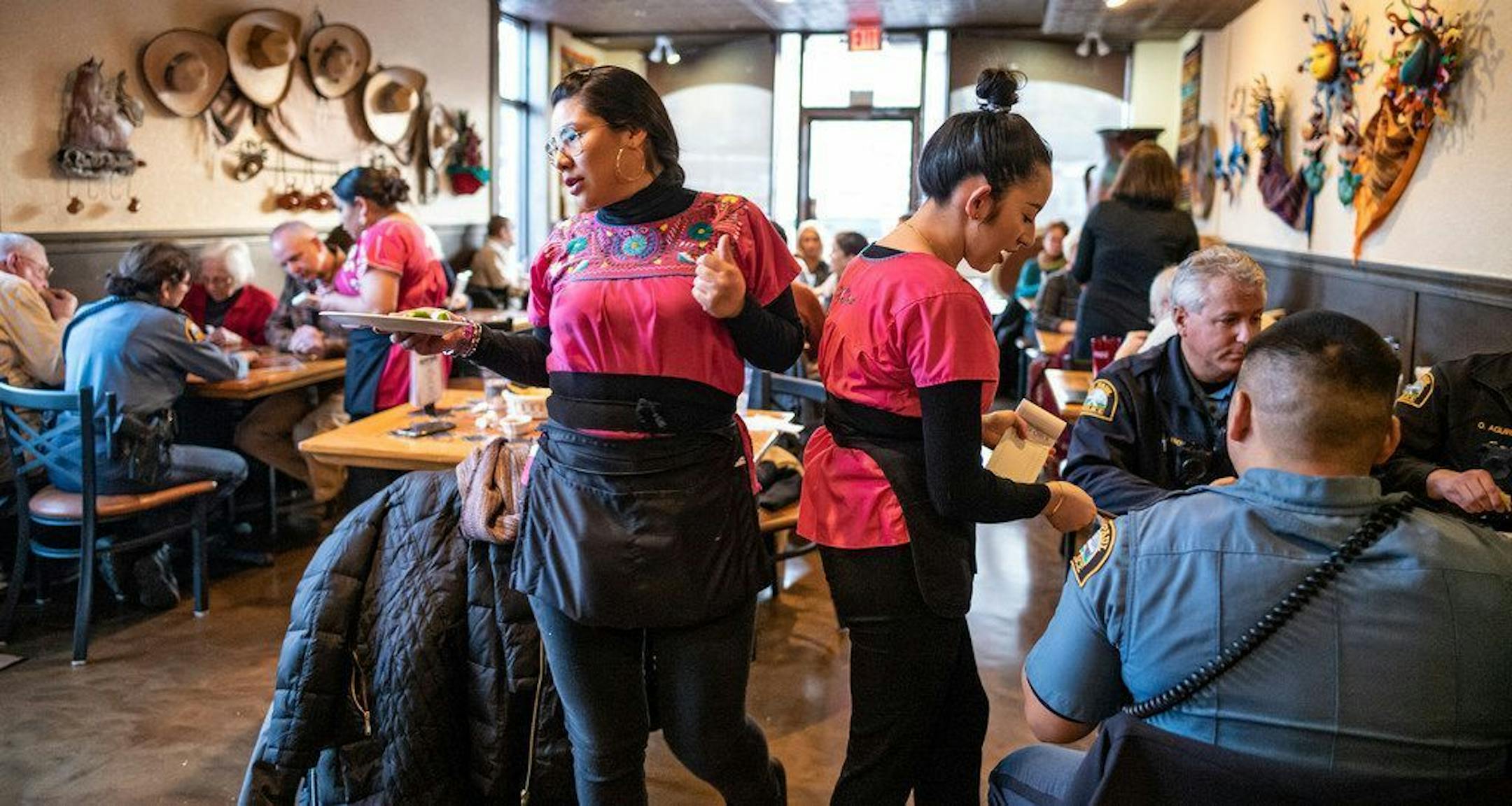 Neighbors, police officers, and members of the St. Paul Town Hall Facebook group gathered in support of El Burrito Mercado after a takeover style robbery in January. RICHARD TSONG-TAATARII