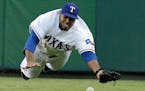 Texas Rangers right fielder Nelson Cruz is unable to reach a single by New York Yankees' Derek Jeter in the second inning of a baseball game Wednesday