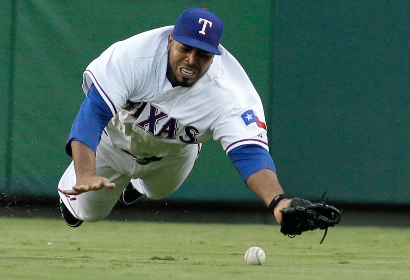 Texas Rangers right fielder Nelson Cruz is unable to reach a single by New York Yankees' Derek Jeter in the second inning of a baseball game Wednesday, Aug. 11, 2010, in Arlington, Texas.