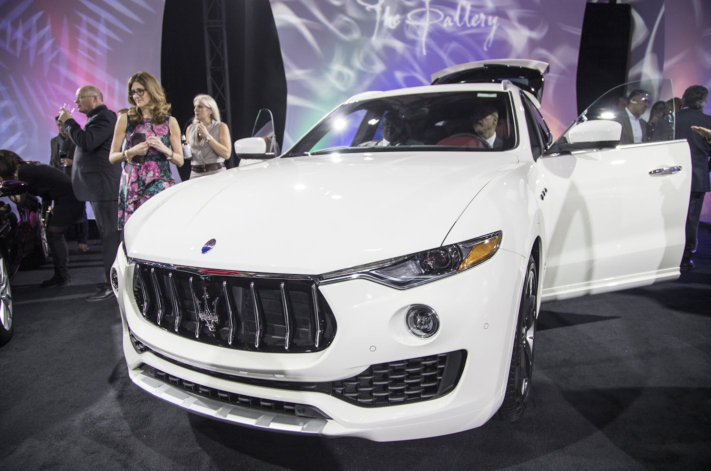 People check out a 2018 Maserati Levante S Granlusso during the Gallery held at Cobo Center in downtown Detroit on January 13, 2018. (Junfu Han/Detroit Free Press/TNS) ORG XMIT: 1233084