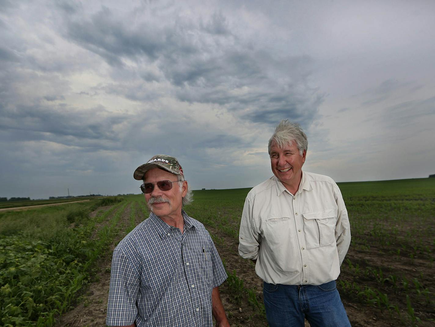 Dave Butler (left) has never lived on a farm, but his father and grandparents did. Butler and his two brothers inherited 440 acres west of Hutchinson, and work with U.S. Bank to manage the property and lease it to nearby farmers. The business of managing farms is on the rise, as the average age of farmers increases and more crop land passes to non-farming younger generations that need help with rental agreements, taxes and other financial decisions. At right is farm manager Jim Myhra. ] JIM GEHR