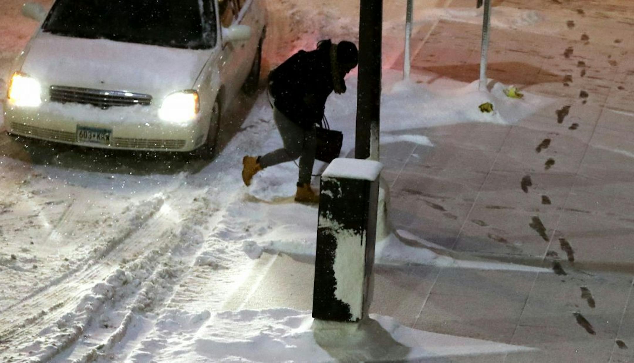 A pedestrian navigates fresh snow outside the US Bank Plaza Wednesday, Jan. 11, 2016, in Minneapolis, MN.