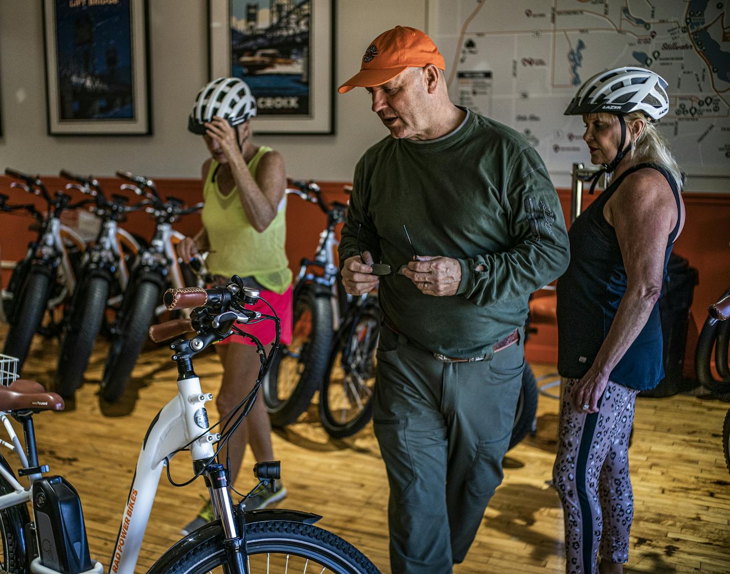 Mike Herman of Mike's Electric bikes explains to friends Sue Anderson, left and Lucia Borgen, right how the electric assist works.] Finally connected by a historic bridge and opened to the public, Stillwater's new Loop Trail has been a popular destination for cyclists and pedestrians this summer. The 4.7-mile trail that winds through Stillwater and Wisconsin carries people across the St. Croix River twic RICHARD TSONG-TAATARII ¥ richard.tsong-taatarii@startribune.com