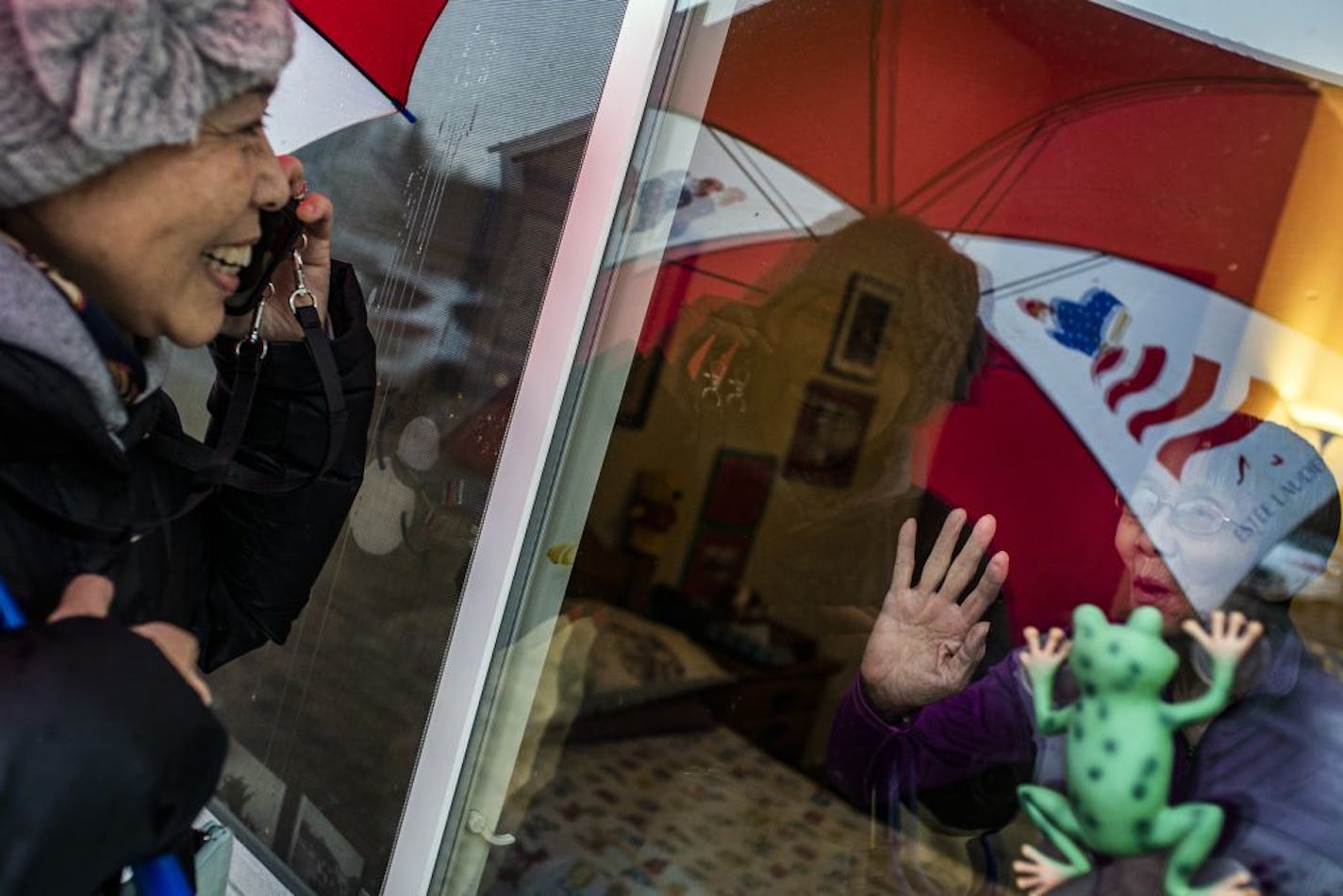 Danielle Jin, 57, visited her mother, Juan Zhu, 91, at an assisted-living facility in Vadnais Heights. Jin must talk to her mother at the window because the facility will not allow family members to visit during the coronavirus outbreak. Her mother has Alzheimer's but still recognizes her daughter. Jin brings her mother some Chinese food for dinner daily.