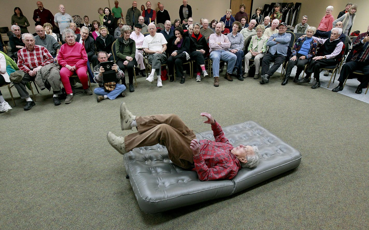 Elliott Royce, 94, demonstrated how to fall to a group of seniors at the Sabes Jewish Community Center, Thursday, February 12, 2015 in St. Louis Park, MN. Royce estimates that he has fallen down at least 14,000 times to teach people -- primarily seniors -- how to fall safely if they are undone by slippery sidewalks. ] (ELIZABETH FLORES/STAR TRIBUNE) ELIZABETH FLORES &#x2022; eflores@startribune.com