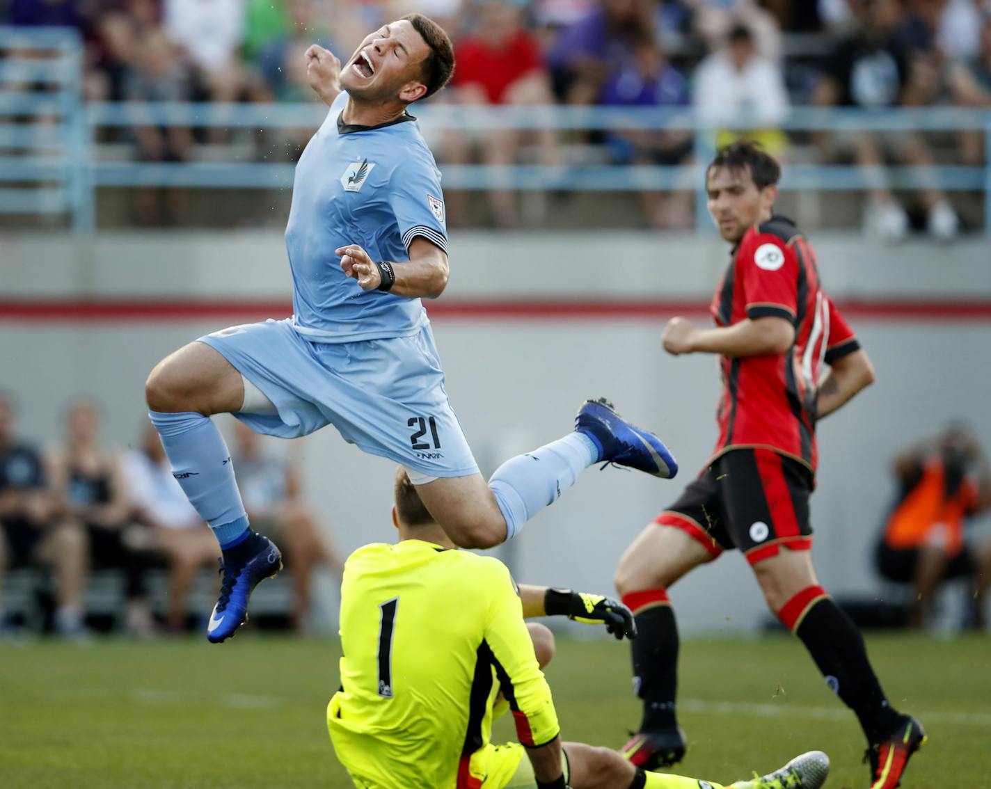 Christian Ramirez (21) leapt past AFC Bournemouth goalie Artur Boruc in the first half. ] CARLOS GONZALEZ cgonzalez@startribune.com - July 20, 2016, Blaine, MN, National Sports Center, Soccer, Minnesota United vs. Bournemouth