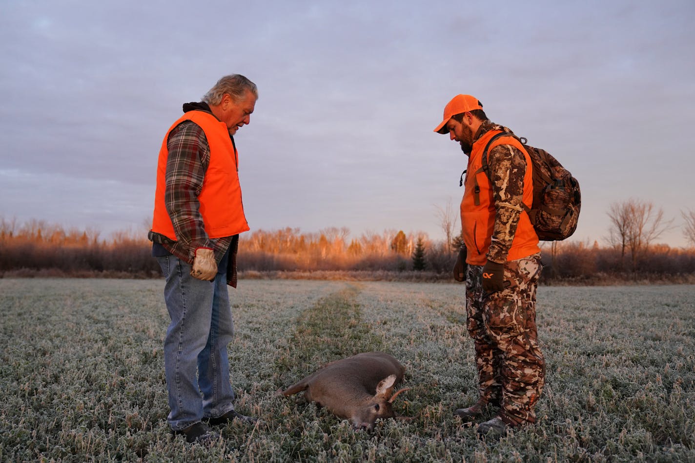 Travis Pennings and his uncle Dan Pennings stopped to look over a deer Travis shot in 2018.