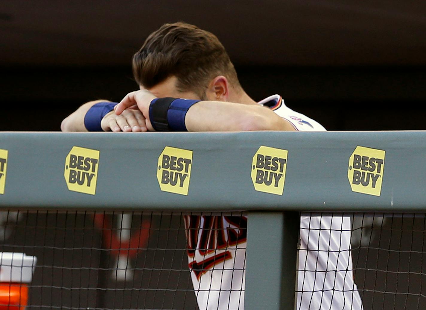 Minnesota Twins Trevor Plouffe rests his head on his hands in the final minutes of a baseball game against the Chicago White Sox Monday, April 11, 2016, in Minneapolis. The White Sox won 4-1, handing the Twins their seventh loss against no wins for the young season.