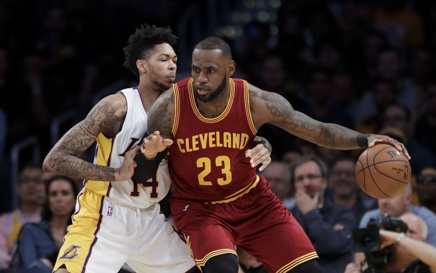 Cleveland Cavaliers' LeBron James, right, is defended by Los Angeles Lakers' Brandon Ingram during the first half of an NBA basketball game Sunday, March 19, 2017, in Los Angeles.