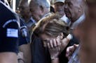 Pensioners crowd the entrance of bank in Athens, Wednesday, July 1, 2015. Long lines formed as bank branches around the country were ordered by Greece