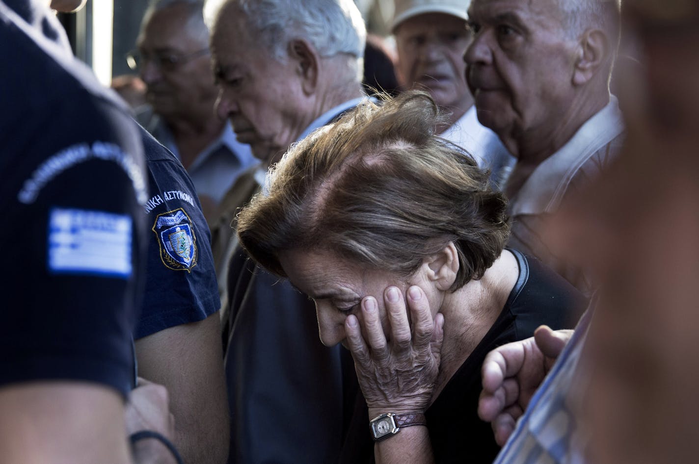 Pensioners crowd the entrance of bank in Athens, Wednesday, July 1, 2015. Long lines formed as bank branches around the country were ordered by Greece's government to reopen Wednesday to help desperate pensioners without ATM cards cash up to 120 euros ($134) from their retirement checks. (AP Photo/Petros Giannakouris)