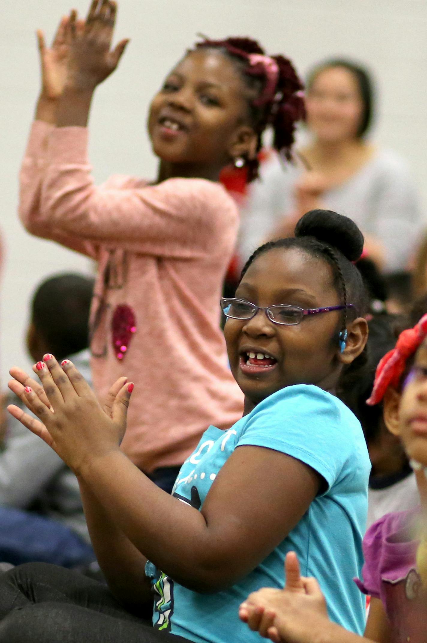 Jie Ming Mandarin Immersion Academy students, who attend classes in a wing of Hamline Elementary School, performed songs and dances for Hamline Elementary students as part of Chinese New Year festivities. Here, Hamline first graders Naomi Agboh, rear, and Makaiya Wilson clap for the Jie Ming performers Tuesday, Feb. 17, 2015, in St. Paul, MN.](DAVID JOLES/STARTRIBUNE)djoles@startribune.com Four years ago, the St. Paul School District launched a Chinese immersion program, and started small -- wit