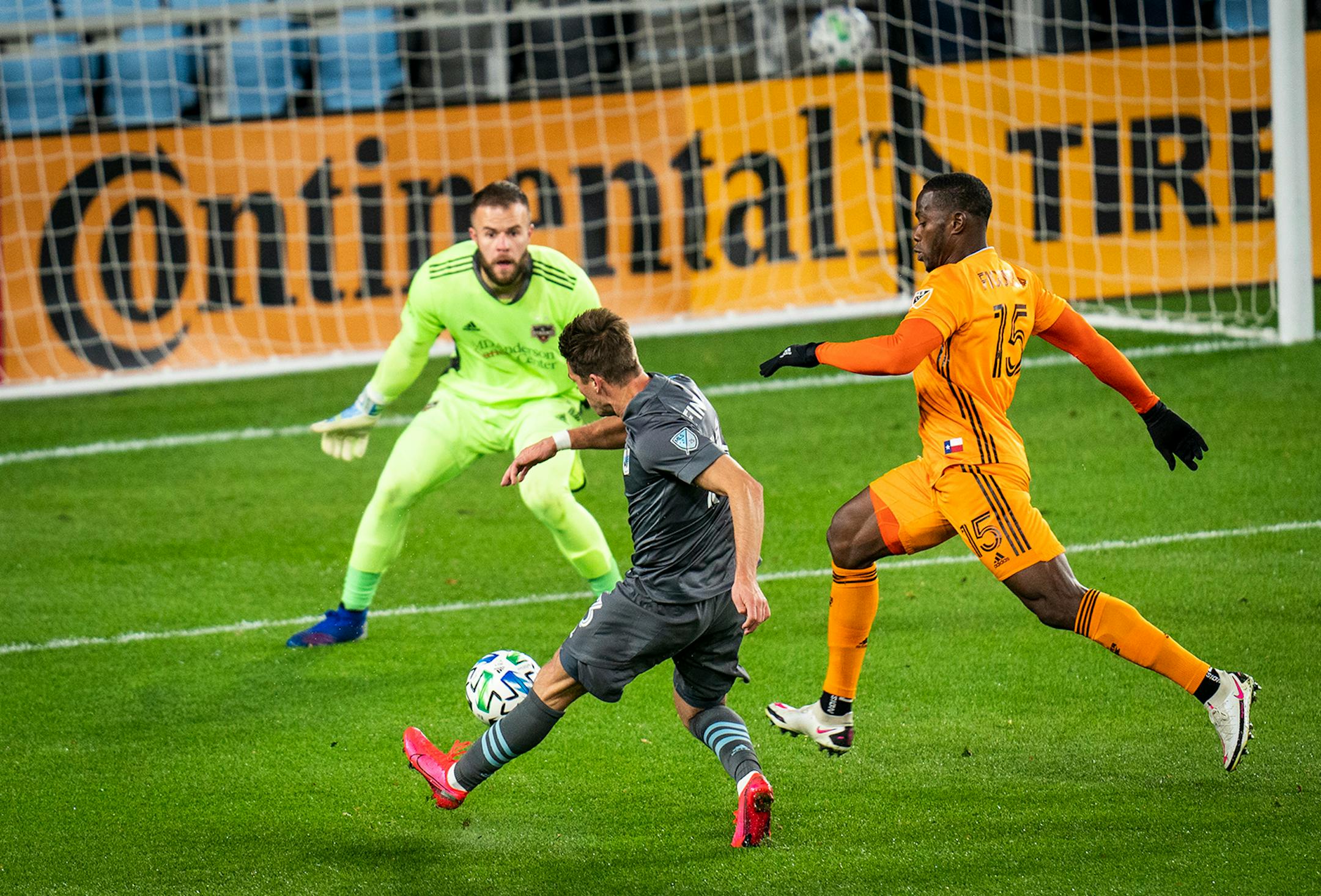 Minnesota United midfielder Ethan Finlay (13) scored a goal on Houston Dynamo goalkeeper Marko Maric (1) as Houston Dynamo defender Maynor Figueroa (15) pursued during the first half.