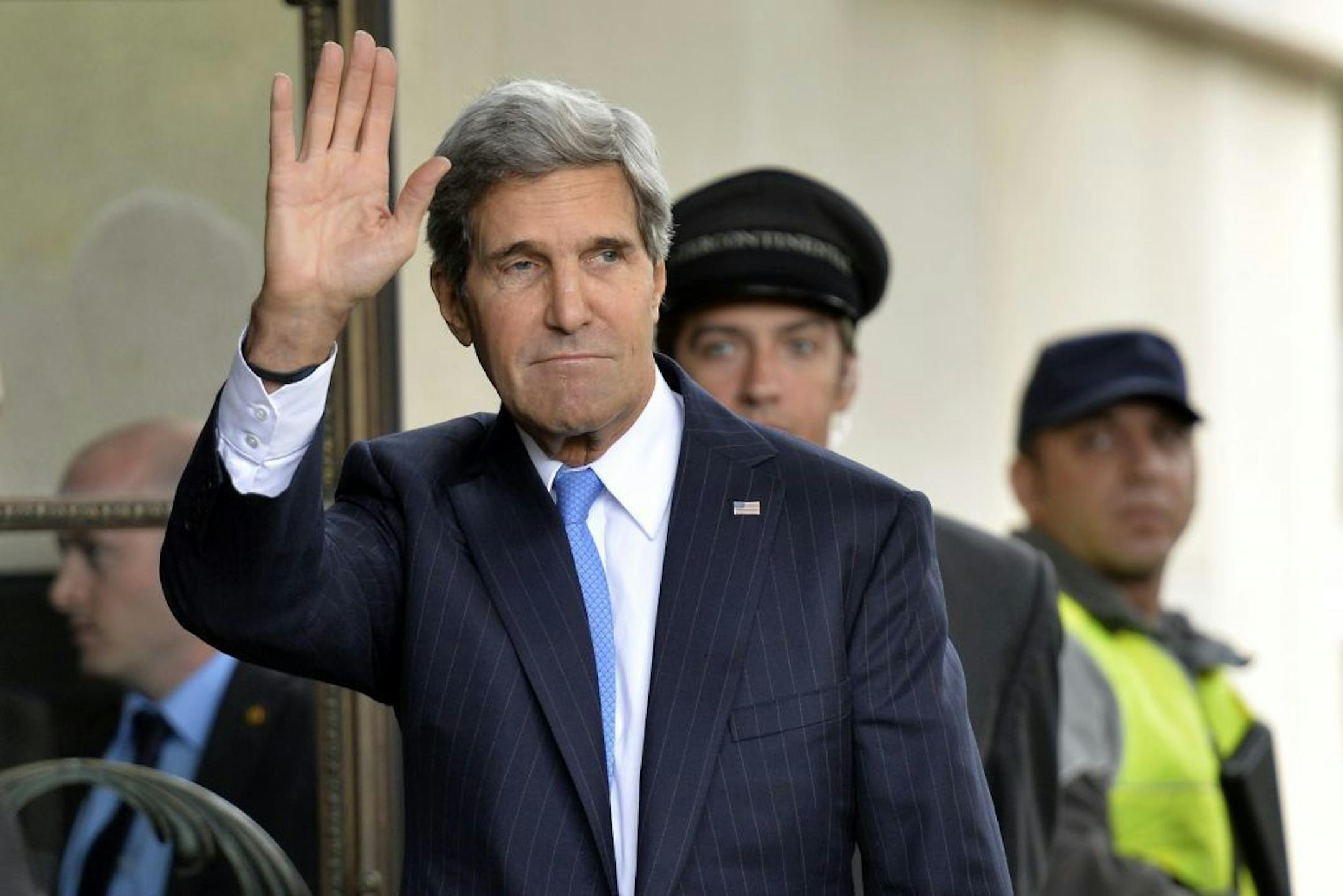 U.S. Secretary of State John Kerry waves as he arrives in Geneva, Switzerland, Thursday, Sept. 12, 2013, to test the seriousness of a Russian proposal to secure Syria's chemical weapons. Kerry and a team of U.S. experts will have at least two days of meetings with their Russian counterparts on Thursday and Friday. They hope to emerge with an outline of how some 1,000 tons of chemical weapons stocks and precursor materials as well as potential delivery systems can be safely inventoried and isolat