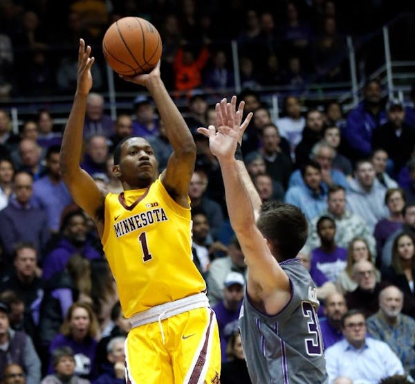 Dupree McBrayer, left, shoots over Northwestern guard Bryant McIntosh during the first half