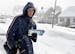 Mail carrier Greg Holler walks his route in West York as snow begins to fall on Saturday, Dec. 14, 2013.