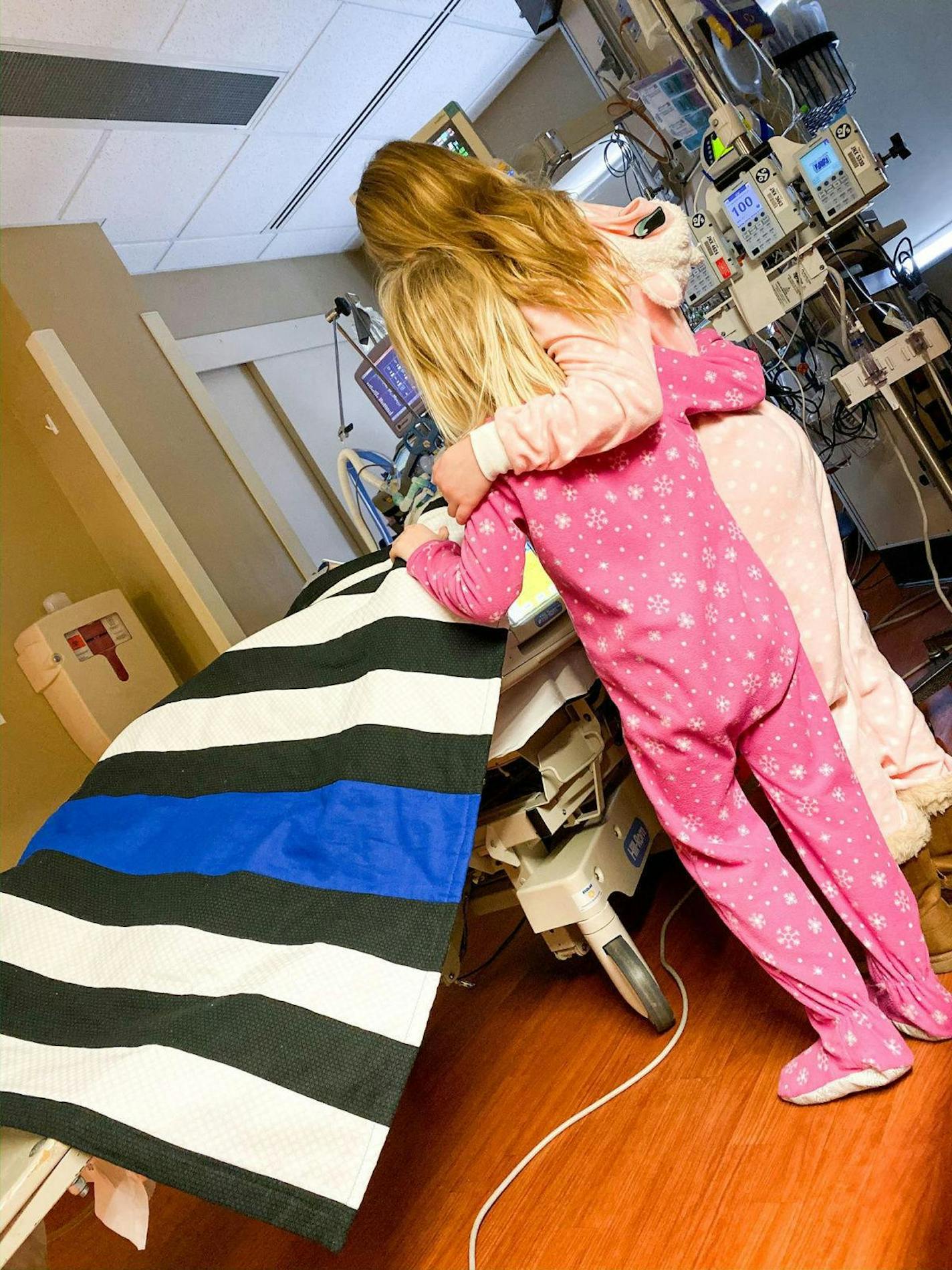 Waseca police officer Arik Matson had some company in his North Memorial hospital room from daughters Audrina and Maklynn. (CaringBridge site family photo)