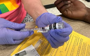 A city staffer prepared a vaccine at a Minneapolis Health Department vaccine clinic.