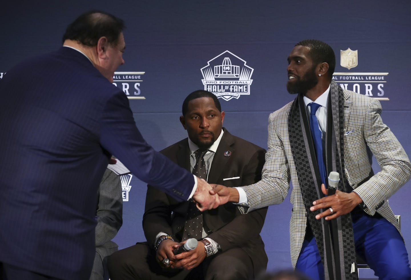 Randy Moss was congratulated by Pro Football Hall of Fame President David Baker after he arrived on the stage with the other members present, including Ray Lewis, center. Randy Moss is only the third wide receiver to be selected for the NFL Hall of Fame on the first ballot.