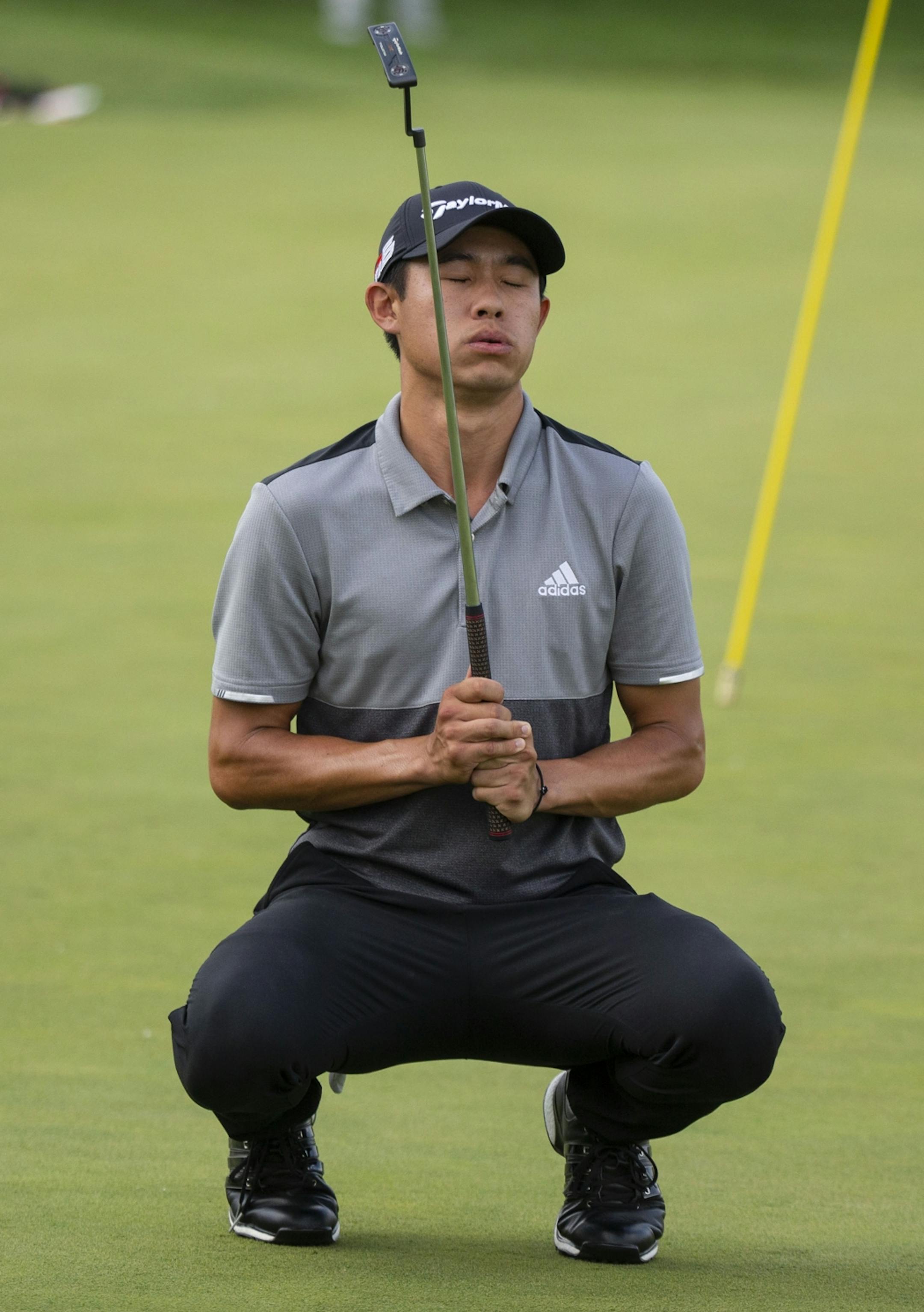 Collin Morikawa reacts after missing a birdie putt on the 17th hole.