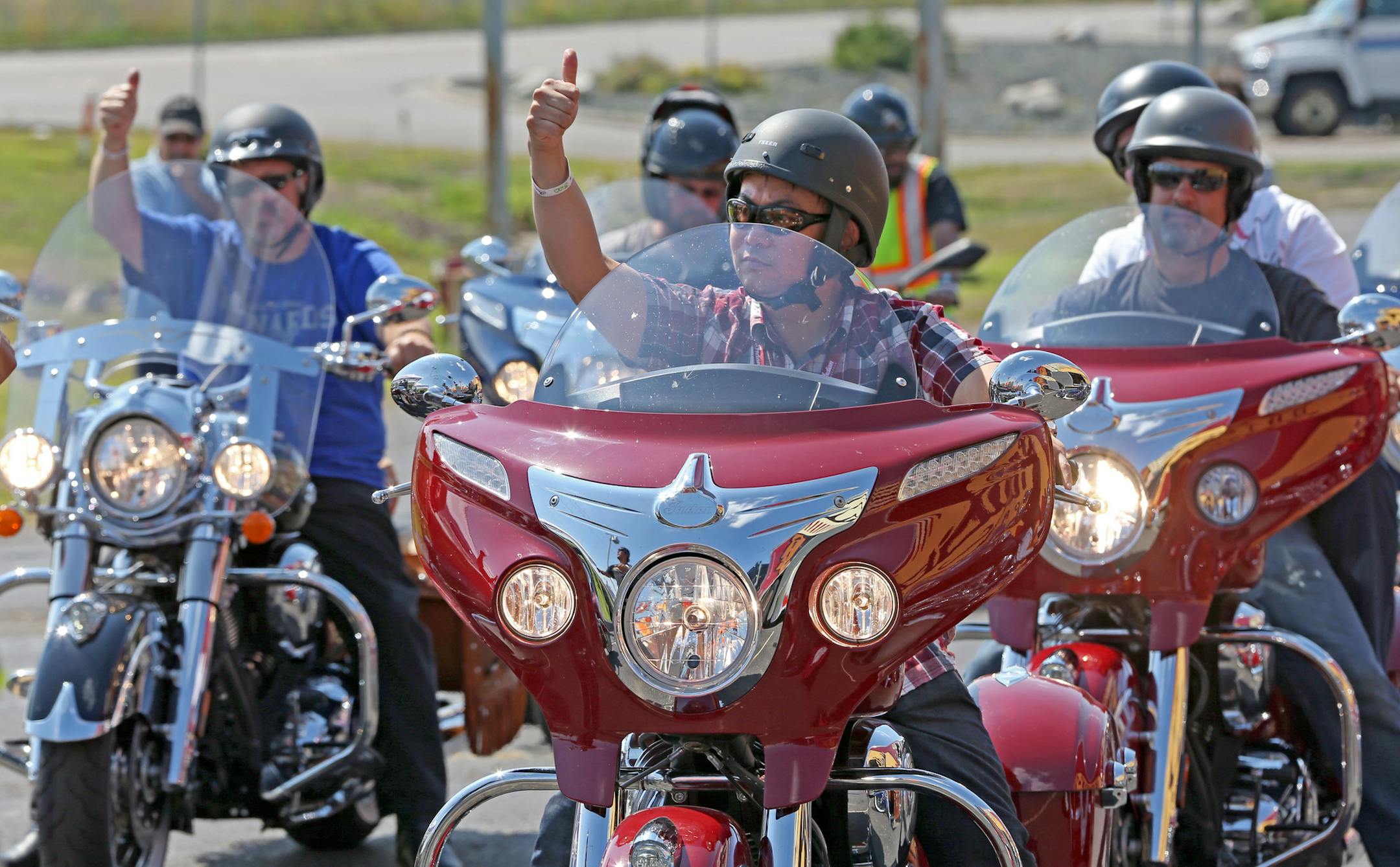 (center) Jay Elepano of Minneapolis gave a thumbs-up as he and other bikers tried out the new line of 2014 Indian motorcycles during a demo event at the Twin Cities Indian Motorcycle dealer in St. Paul on 8/16/13. The event was the first demonstration of the Indian bikes in Minnesota since they were launched at the Sturgis Motorcycle ralley.] Bruce Bisping/Star Tribune bbisping@startribune.com Jay Elepano/source.