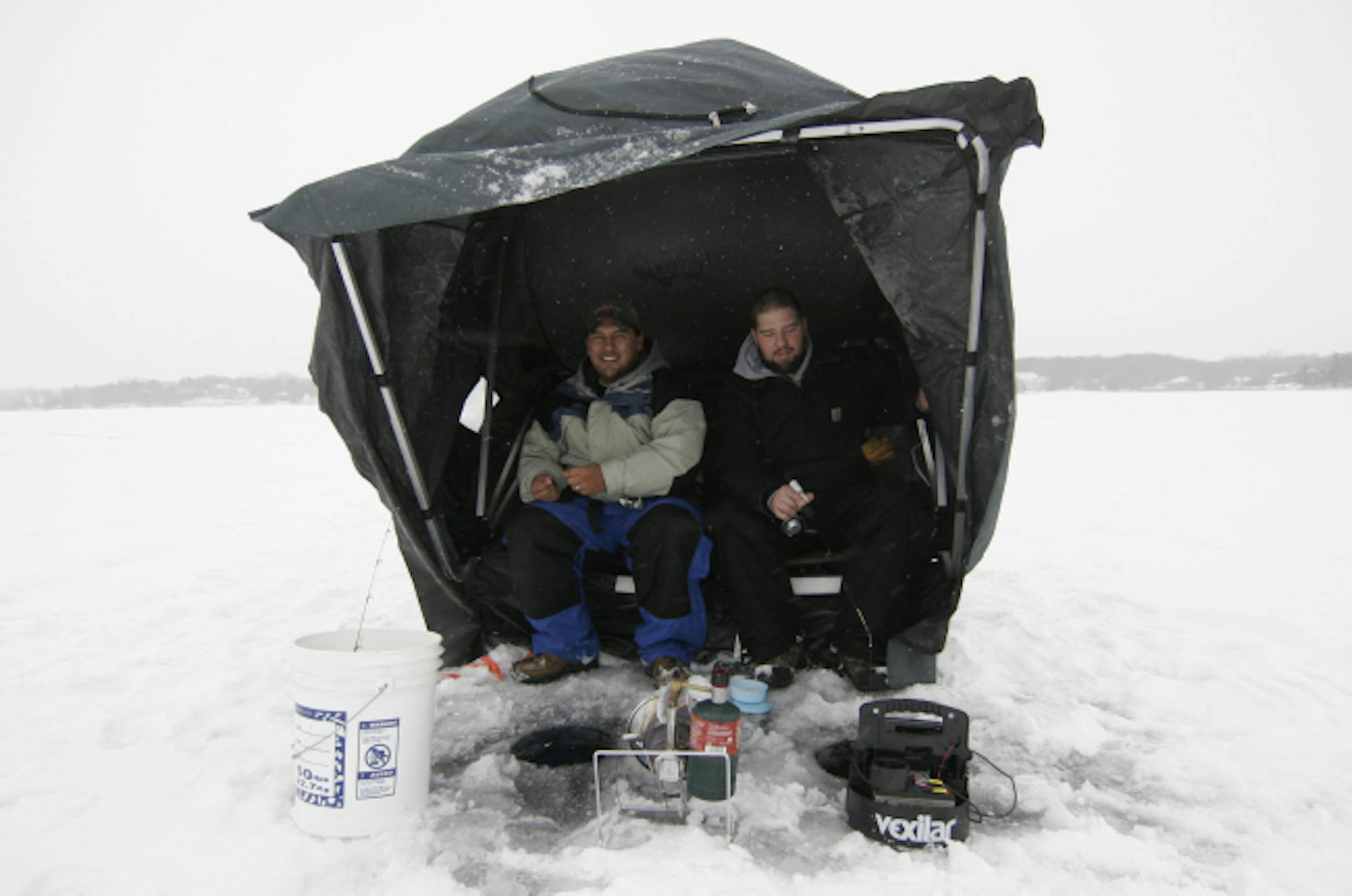 Nate Ryan, 27, and buddy Jade Ohlund, 31 — both of Dundas, Minn. — were among the early-season anglers ice fishing on Orchard Lake in Lakeville on Sunday. "I personally like it better than open-water fishing," Ryan said. "It's my favorite time of the year, by far."