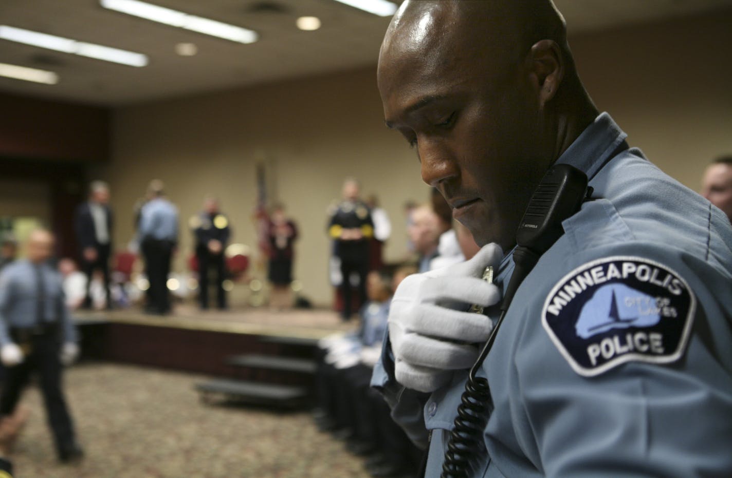 New Minneapolis Police Department Academy graduate Michael Griffin pins his badge onto his uniform moments after receiving it from Police Chief Tim Dolan at the graduation ceremony Thursday evening. GENERAL INFORMATION: JEFF WHEELER &#x2022; jwheeler@startribune.com MINNEAPOLIS - Minneapolis Mayor R.T. Rybak attended the graduation ceremony for two classes of Minneapolis Police Department recruits Thursday evening at the Zuhrah Shrine Center in Minneapolis. The police department gained 31 new of