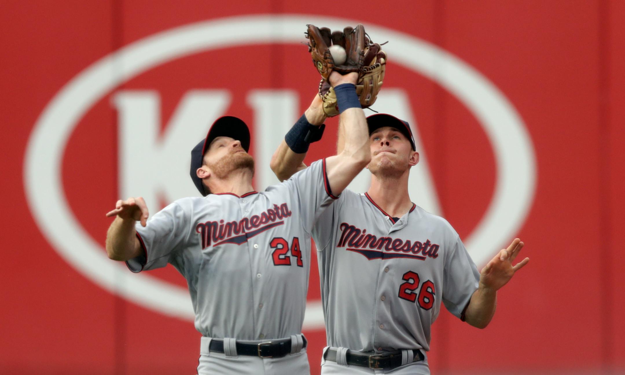Minnesota Twins' Logan Forsythe (24) and Max Kepler (26) collide as Forsythe catches a ball hit by Cleveland Indians' Jose Ramirez in the first inning of a baseball game, Monday, Aug. 6, 2018, in Cleveland. Ramirez was out on the play. (AP Photo/Tony Dejak)