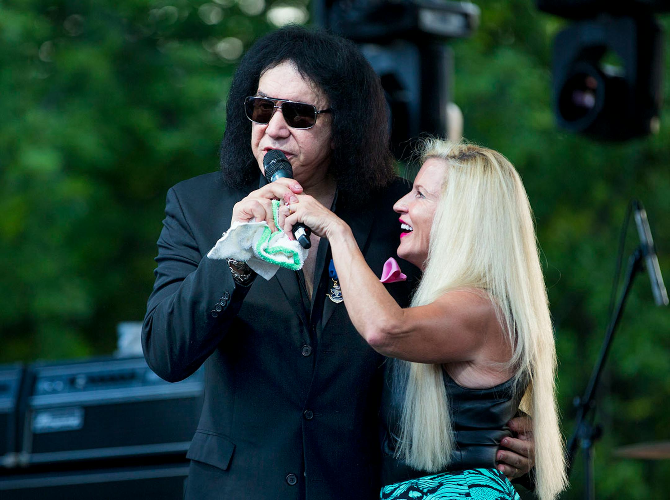 Kiss' Gene Simmons spoke with philanthropist Martha "Muffy" MacMillan on stage before a charity concert at MacMillan's home on Tuesday, August 2, 2016, in Long Lake, Minn.