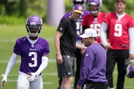 Vikings wide receiver Jordan Addison (3) demonstrates a drill Wednesday while rookie quarterback J.J. McCarthy (9) looks on.