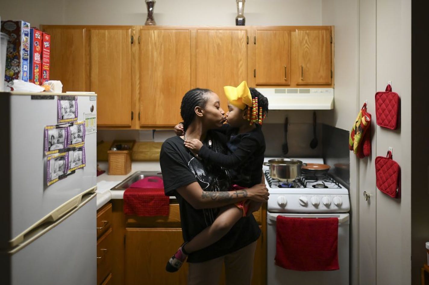 Shanta Russ, 22, kissed her daughter, Siya Freeman, 4, after being allowed back up to her father's 15th floor apartment, following a fire on the 14th floor in Minneapolis on Wednesday, Nov. 27, 2019. Several people died and three were injured when the fire broke at the public housing high-rise in a heavily immigrant neighborhood of Minneapolis early Wednesday.