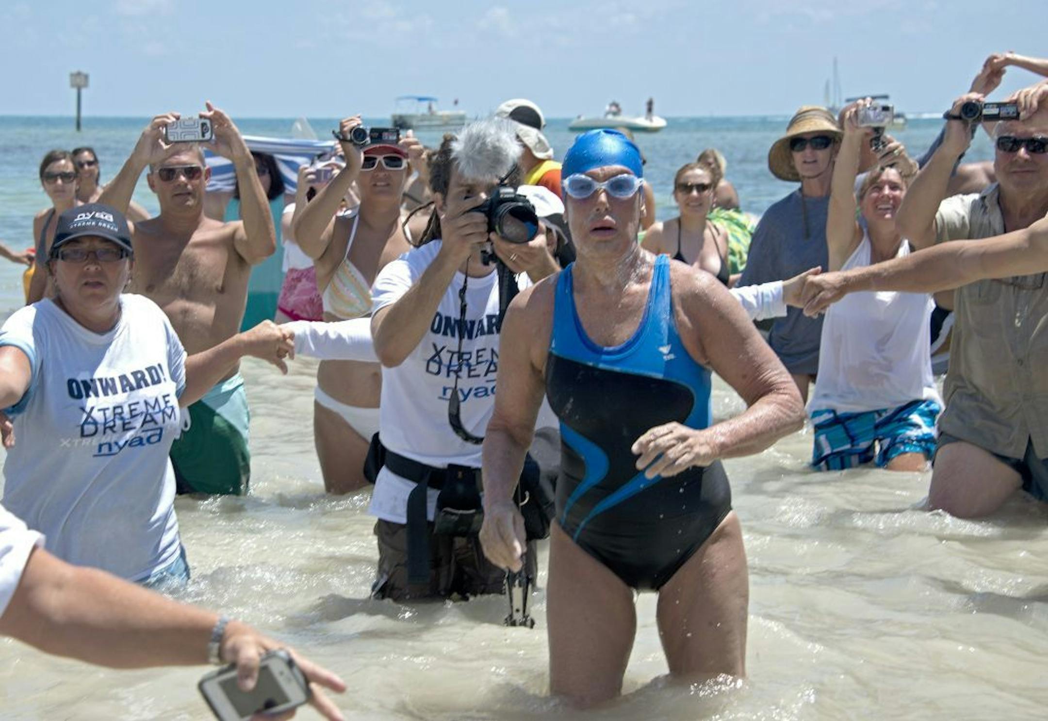 FILE - In this Monday, Sept. 2, 2013 fi, Diana Nyad emerges from the Atlantic Ocean after completing a 111-mile swim from Cuba to Key West, Fla.