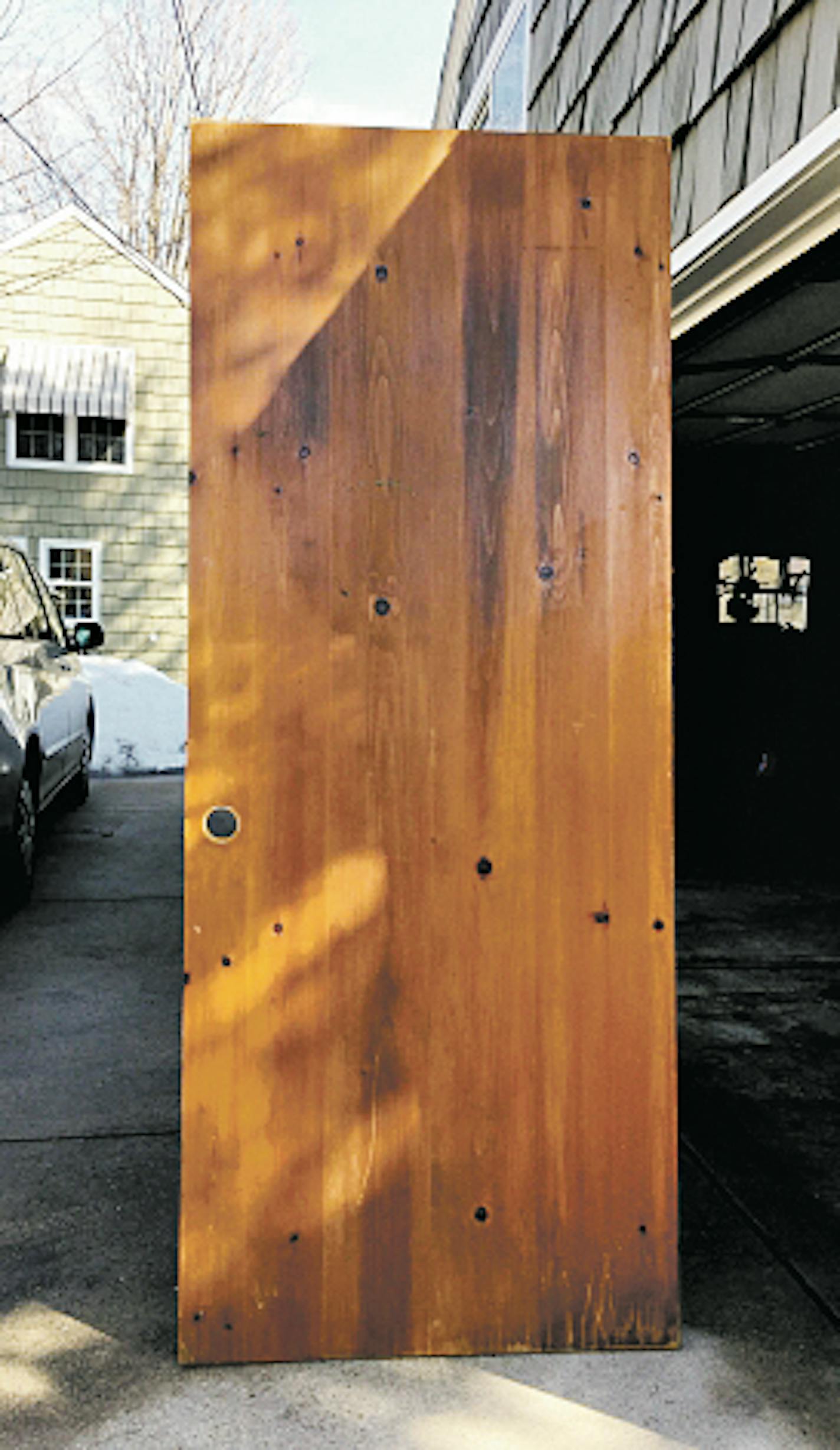 The salvaged door became kitchen shelving.