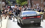 A vehicle drives into a group of protesters demonstrating against a white nationalist rally in Charlottesville, Va., Saturday, Aug. 12, 2017. The nati