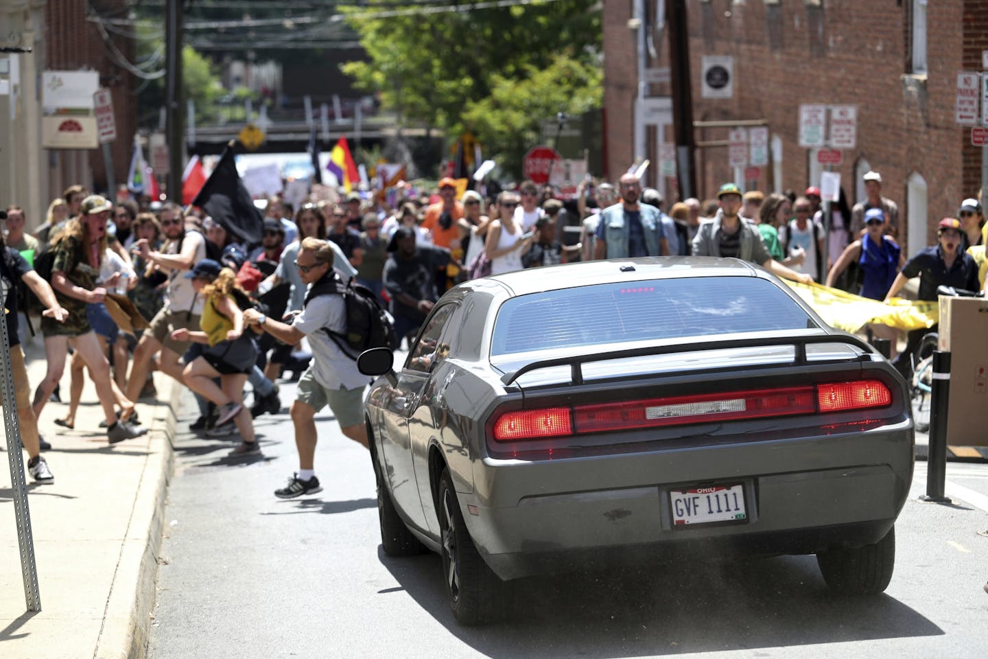 A vehicle drives into a group of protesters demonstrating against a white nationalist rally in Charlottesville, Va., Saturday, Aug. 12, 2017. The nationalists were holding the rally to protest plans by the city of Charlottesville to remove a statue of Confederate Gen. Robert E. Lee. There were several hundred protesters marching in a long line when the car drove into a group of them. /The Daily Progress via AP)