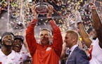 Ohio State Buckeyes head coach Urban Meyer celebrates with his team after their 27-21 Big Ten Champsionship win over the Wisconsin Badgers at Lucas Oi