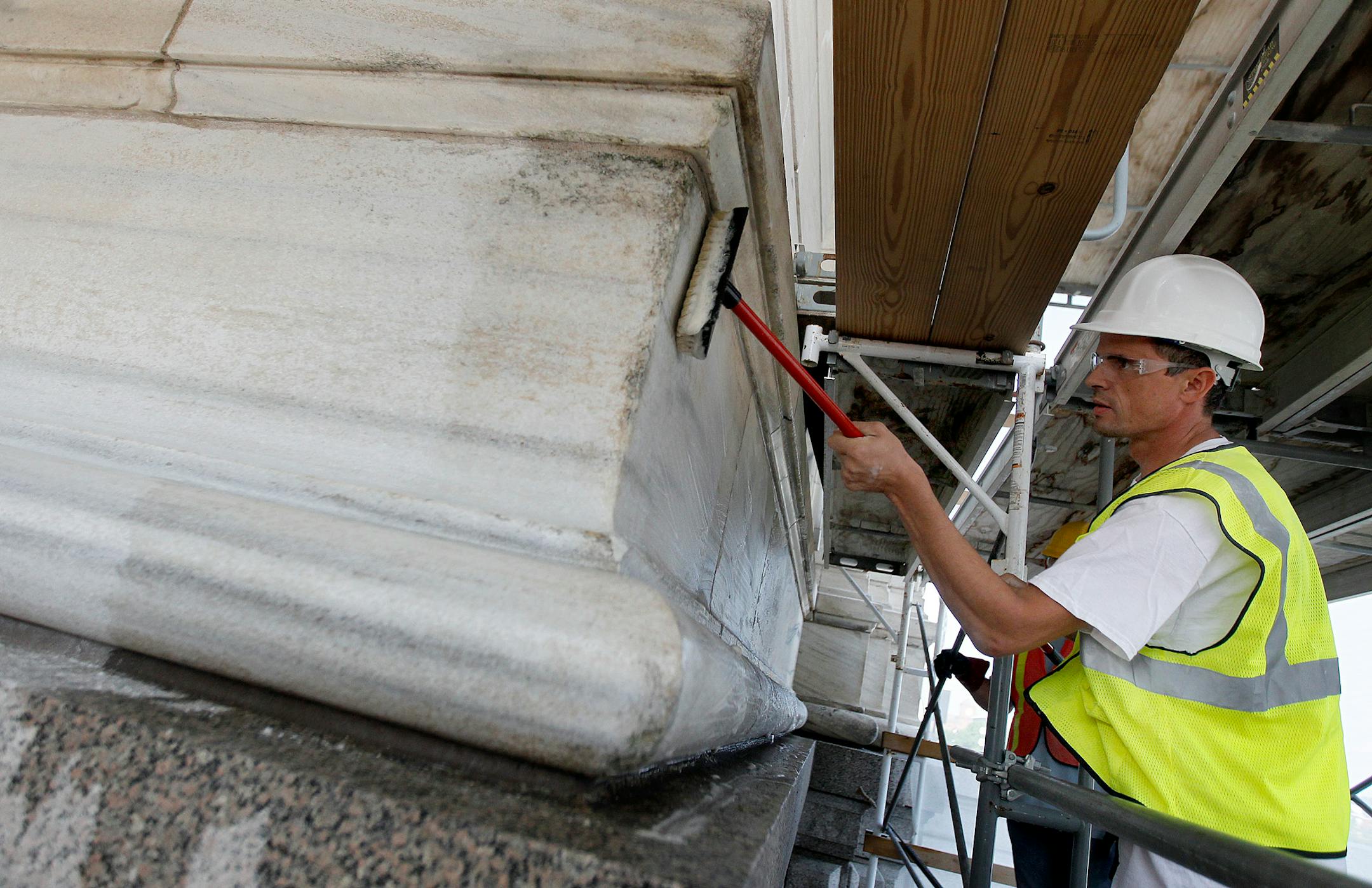 Joseph Walus worked on cleaning the outside of the North end of the State Capitol as stone restoration and repair began at the State Capitol Wednesday, July 10, 2013 in St. Paul.