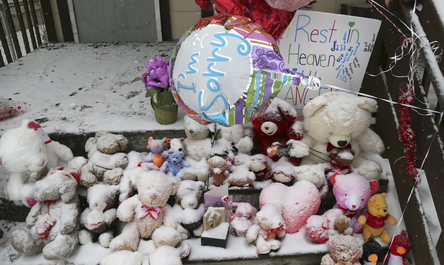 Stuffed animals are coated in fresh snow prior to the start of a vigil held outside the charred duplex at 2818 Colfax Ave. N. Saturday, Feb. 15, 2014, in Minneapolis, MN. A day earlier five siblings, including three children, lost their lives in a fire at the north side duplex.](DAVID JOLES/STARTRIBUNE) djoles@startribune.com A day after a northside fire took the lives of five, including three children, a steady stream of vehicles with onlookers inside rolled slowly by the duplex, some snapping