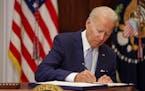 President Joe Biden signs the Bipartisan Safer Communities Act into law in the Roosevelt Room of the White House on Saturday, June 25, 2022.