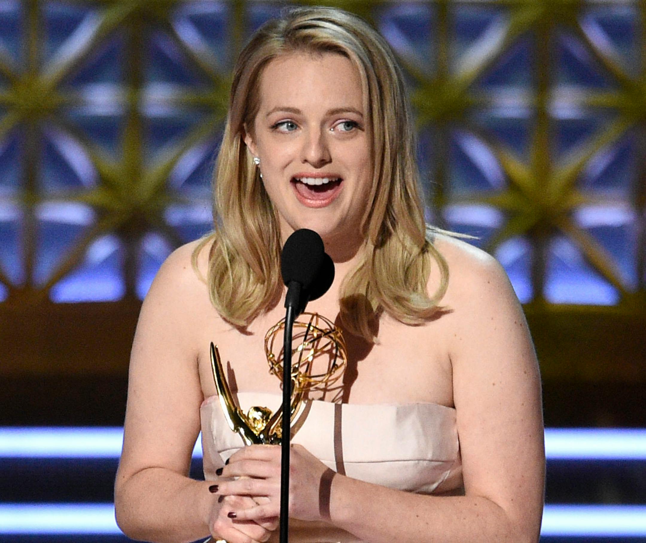 Elisabeth Moss accepts the award for outstanding lead actress in a drama series for "The Handmaid's Tale" at the 69th Primetime Emmy Awards on Sunday, Sept. 17, 2017, at the Microsoft Theater in Los Angeles.