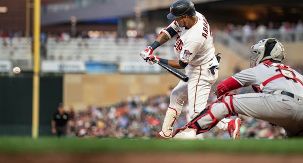 Twins second baseman Luis Arraez swings into a pitch for a three-run home in the seventh inning Tuesday